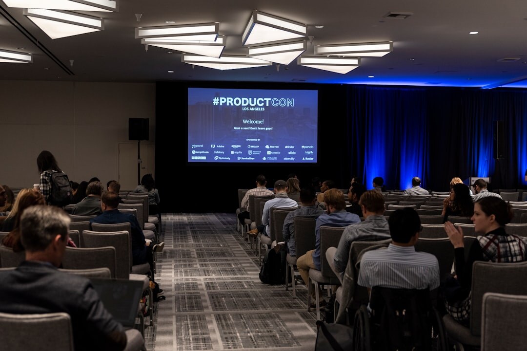 Conference event with speaker presenting on stage to an audience