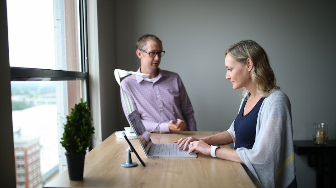 Two professionals conducting a formal interview at a desk