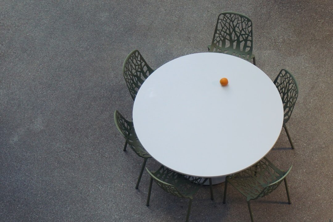 Group of professionals sitting around a round table in discussion